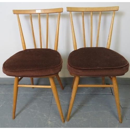 714 - A pair of mid-century Ercol blond stickback occasional chairs, model 391. With removable seat cushio... 