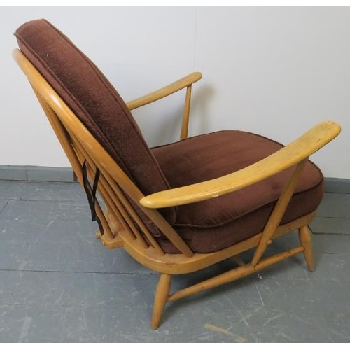 716 - A mid-century Ercol Windsor 203 blond armchair, with loose seat cushions in brown draylon. 
Conditio... 