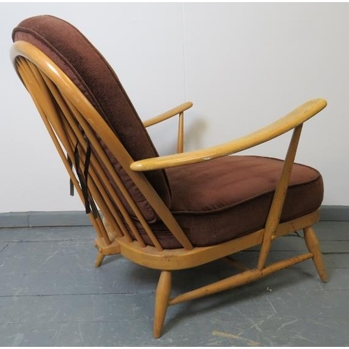 716 - A mid-century Ercol Windsor 203 blond armchair, with loose seat cushions in brown draylon. 
Conditio... 