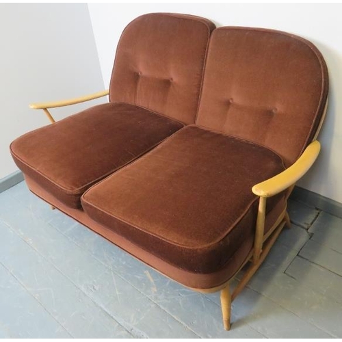 717 - A mid-century Ercol Windsor 203 blond 2-seater sofa, with loose seat cushions in brown draylon.  
Co... 