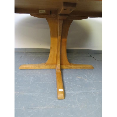 722 - An Ercol ash blonde Southwold oval dining table, on a quatreform pedestal base.
H73cm W163cm D123cm ... 