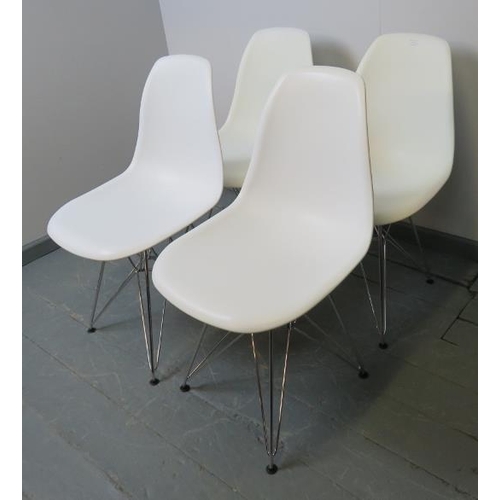 725 - A set of four contemporary shell chairs in the manner of Eames, with polypropylene seats raised on a... 