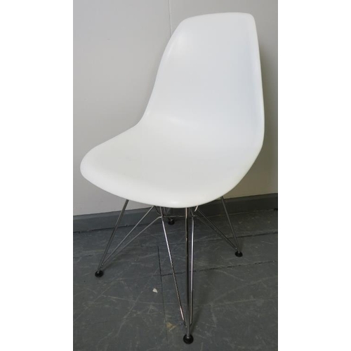 725 - A set of four contemporary shell chairs in the manner of Eames, with polypropylene seats raised on a... 