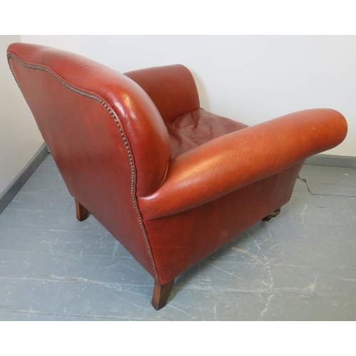 727 - A Victorian style club armchair, upholstered in deep grained brown leather with brass studs, on tape... 