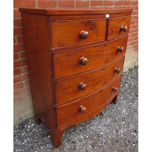 730 - A Georgian mahogany bowfront chest of two short over three long cock beaded drawers, retaining the o... 