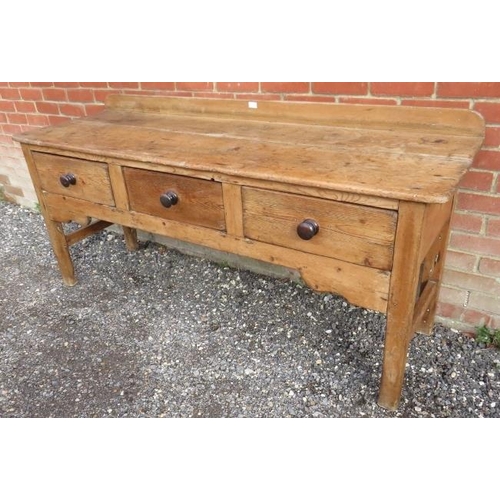 731 - An antique stripped pine sideboard of three drawers with turned wooden knob handles, on square suppo... 