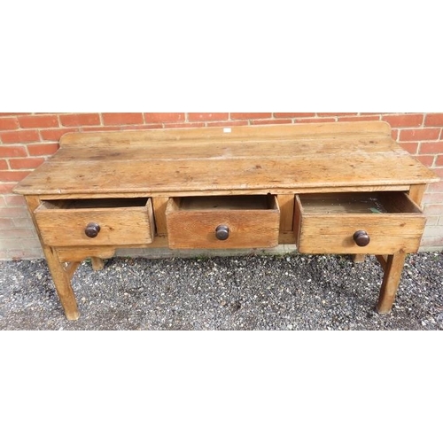 731 - An antique stripped pine sideboard of three drawers with turned wooden knob handles, on square suppo... 