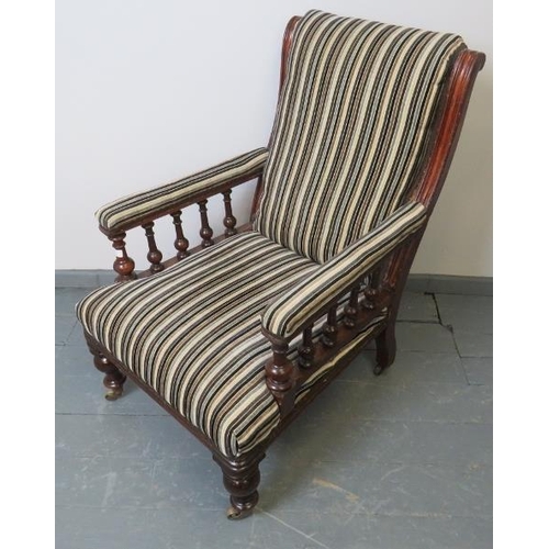 735 - A Victorian mahogany library chair, reupholstered in a contemporary striped chenille material, on ta... 