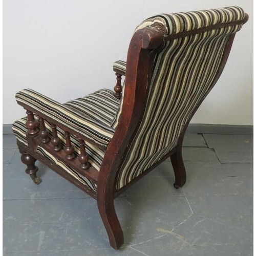 735 - A Victorian mahogany library chair, reupholstered in a contemporary striped chenille material, on ta... 