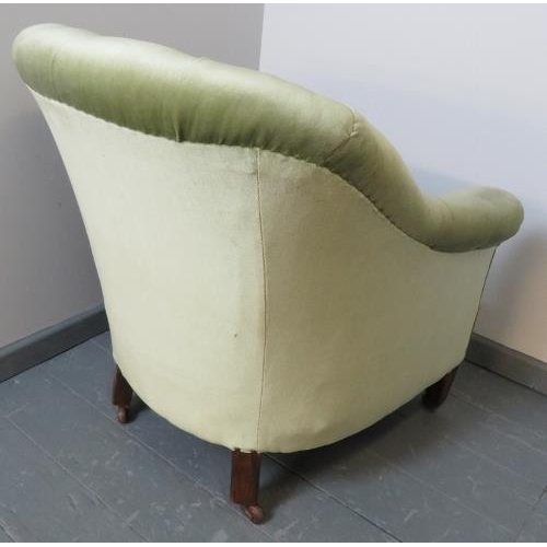 738 - A turn of the century button back armchair, upholstered in green velvet, on tapering square supports... 