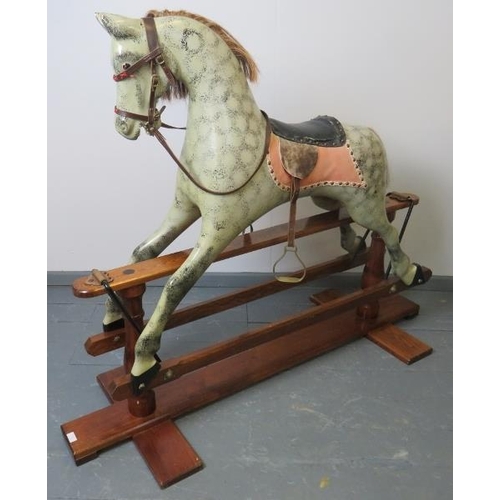 745 - A vintage dapple grey rocking horse, with leather reigns, bridle & saddle and real horsehair mane & ... 