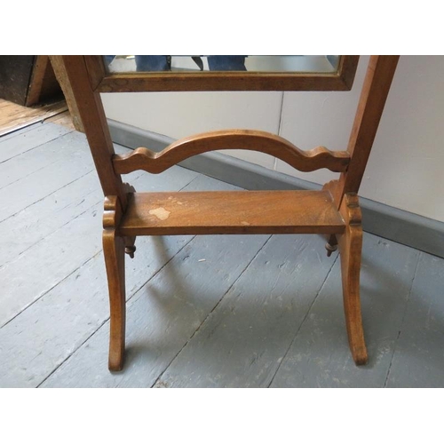 747 - An Edwardian oak bevelled cheval mirror, with square uprights and turned finials, on splayed support... 