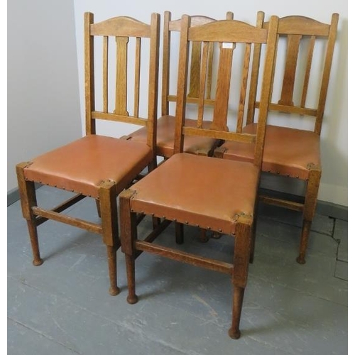 754 - A set of four Arts & Crafts medium oak high back dining chairs in the Liberty taste, on tapering tur... 