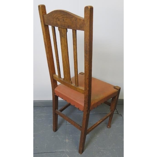 754 - A set of four Arts & Crafts medium oak high back dining chairs in the Liberty taste, on tapering tur... 