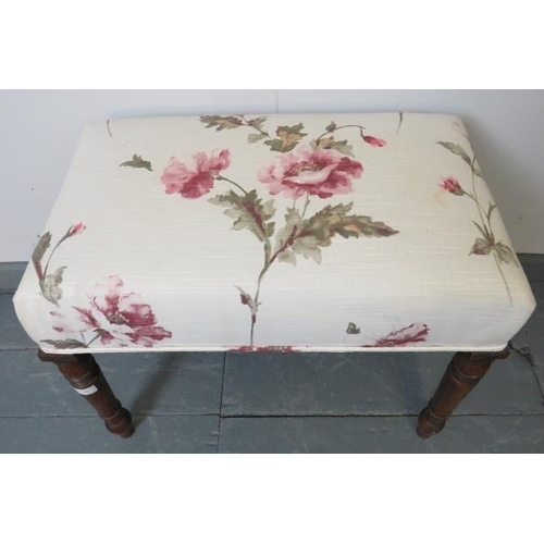 760 - A Victorian mahogany music stool on tapering turned supports, reupholstered in a floral-patterned ma... 