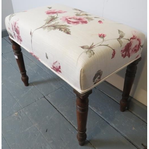 760 - A Victorian mahogany music stool on tapering turned supports, reupholstered in a floral-patterned ma... 