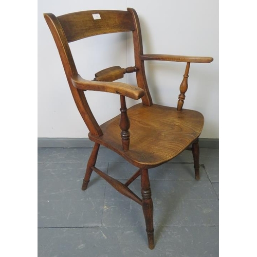 762 - A turn of the century elm and beech open sided armchair, on turned supports with stretchers.
Conditi... 