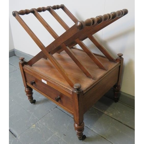 764 - A Regency mahogany X frame Canterbury, with single base drawer, on turned tapering supports with bra... 