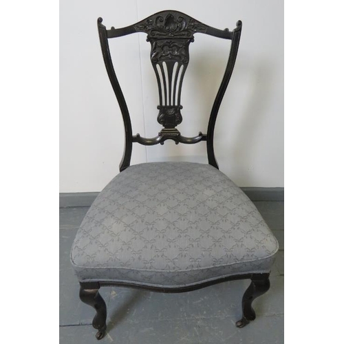 767 - A pair of Edwardian ebonised bedroom chairs, with lyre backs, upholstered in blue pattered material,... 