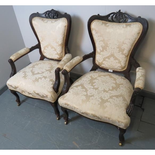 776 - A pair of Victorian mahogany open-sided armchairs, with acanthus carved and pierced cornice and foli... 