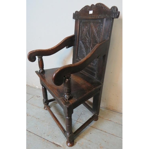 781 - A 17th Century oak Wainscot chair, with carved cornice and carved panel back, on turned and block su... 