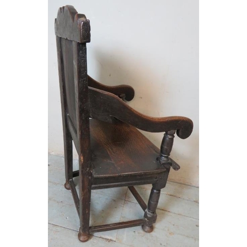 781 - A 17th Century oak Wainscot chair, with carved cornice and carved panel back, on turned and block su... 