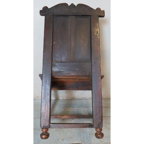 781 - A 17th Century oak Wainscot chair, with carved cornice and carved panel back, on turned and block su... 