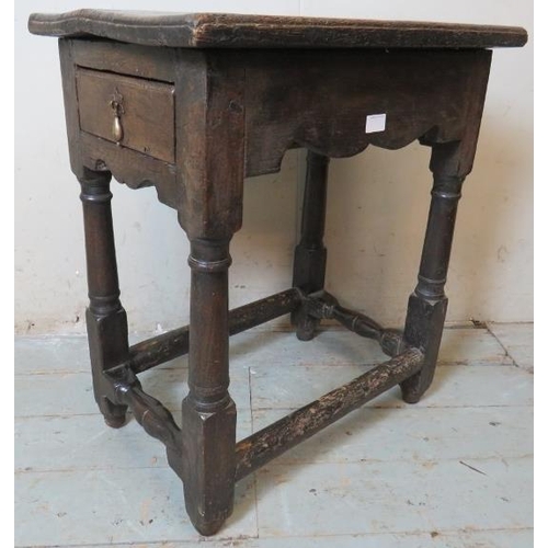 782 - A 17th century oak single drawer side table of excellent colour, on turned and block supports united... 