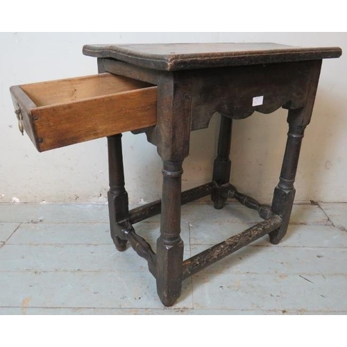 782 - A 17th century oak single drawer side table of excellent colour, on turned and block supports united... 