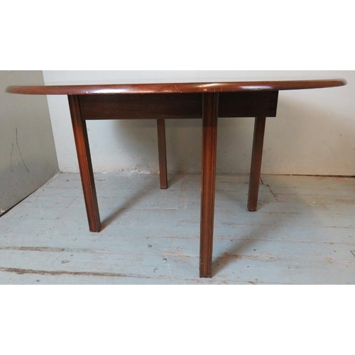 794 - A Georgian style mahogany circular dropleaf dining table, raised on shaped square supports.
Conditio... 