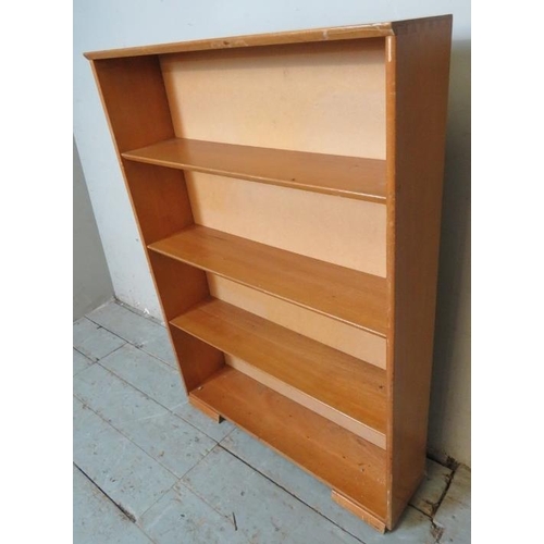 795 - A mid-century teak tall open bookcase by Herbert E Gibbs, of four graduated shelves, raised on block... 