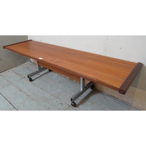 797 - A mid century teak long coffee table, on steel base with castors. 
Condition report: Minor marks con... 