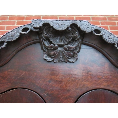 800 - An 18th century Spanish oak linen press with ornately carved pierced shaped cornice over twin cupboa... 