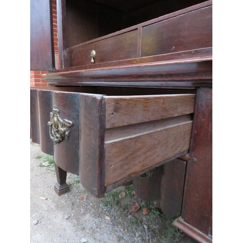 800 - An 18th century Spanish oak linen press with ornately carved pierced shaped cornice over twin cupboa... 