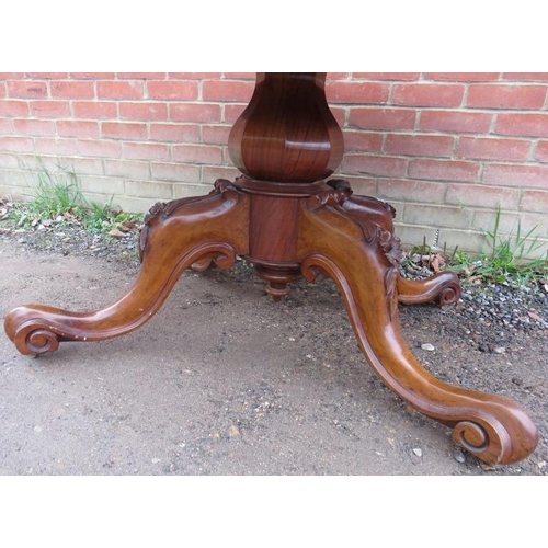 802 - A Victorian walnut oval tilt top loo table, the quarter veneered top raised on a bulbous octagonal c... 