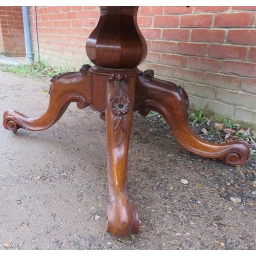 802 - A Victorian walnut oval tilt top loo table, the quarter veneered top raised on a bulbous octagonal c... 