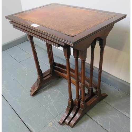 805 - An Edwardian style mahogany nest of three tables with gilt tooled red leather inserts, on faux bambo... 