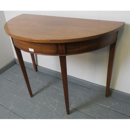 808 - A Georgian mahogany demi lune console table, on tapering square supports. 
Condition report: Minor m... 