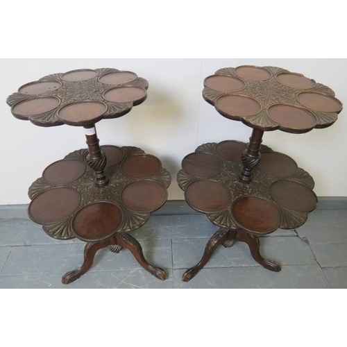 810 - A pair of Edwardian mahogany two tier dumb waiters in a George III style, carved with acanthus leave... 