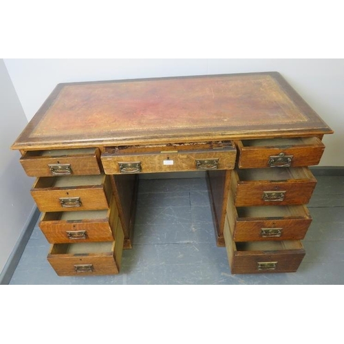 814 - A Victorian oak kneehole pedestal desk, with inset gilt tooled leather writing surface, housing a co... 