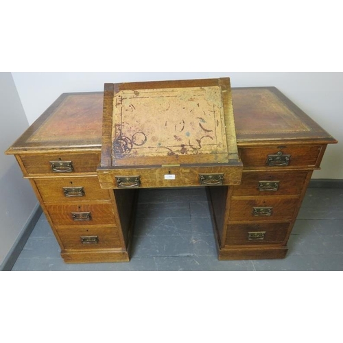 814 - A Victorian oak kneehole pedestal desk, with inset gilt tooled leather writing surface, housing a co... 