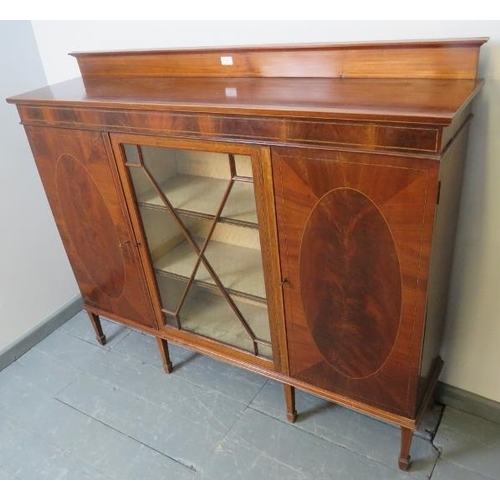 816 - An Edwardian mahogany dwarf display cabinet, with central astral glazed door flanked by two solid do... 