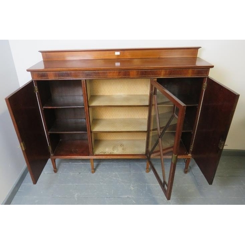 816 - An Edwardian mahogany dwarf display cabinet, with central astral glazed door flanked by two solid do... 