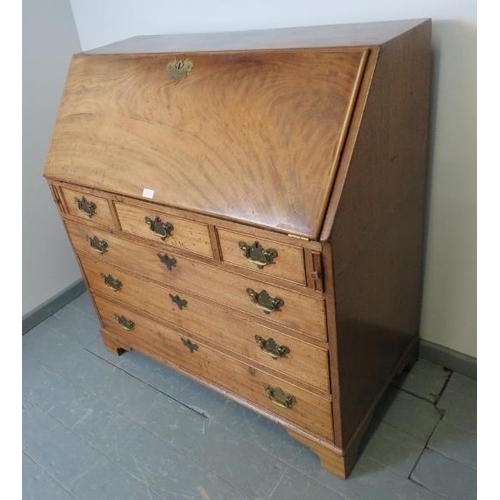 817 - A George III mahogany bureau, the fall front opening onto a fitted interior with central document sa... 