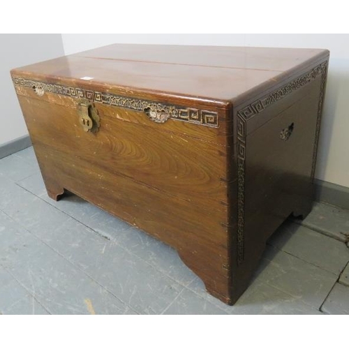 822 - A vintage Chinese camphorwood chest/blanket box with relief carved frieze and two tray inserts. Comp... 