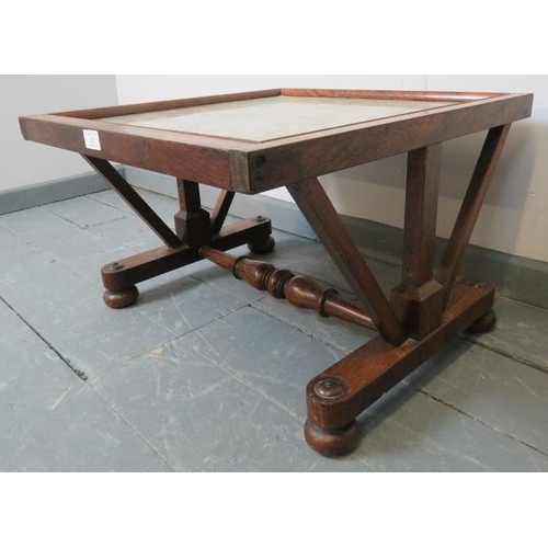 823 - A small Victorian rosewood low occasional table, with inset glass top and tapestry panel, on bun fee... 