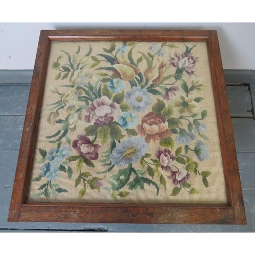 823 - A small Victorian rosewood low occasional table, with inset glass top and tapestry panel, on bun fee... 