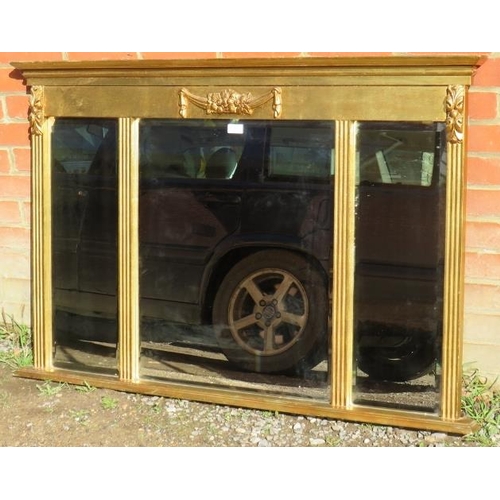 824 - A reproduction gilt three section bevelled overmantle mirror with reeded columns and applied foliate... 