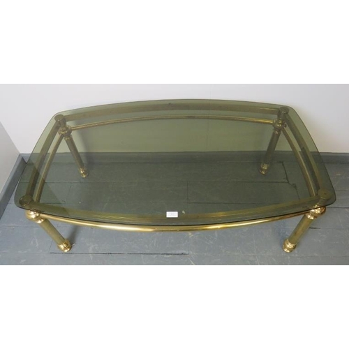 832 - A contemporary coffee table with smoked glass top, on polished brass base.
Condition report: No issu... 