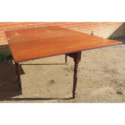 833 - A late Georgian mahogany drop leaf dining table, on tapering turned supports with brass castors. 
Co... 